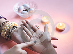 palmistry fortune teller reads lines on hand or palm to tell future.Â 